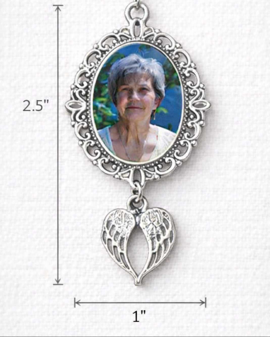 Silver wedding bouquet charm with photo frame and angel wing pendant on a white background